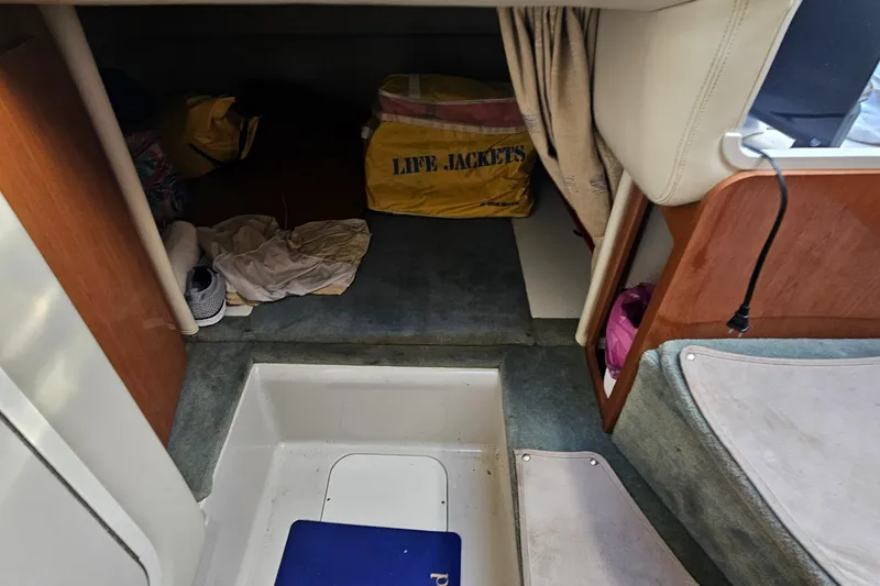 Slide: The Image of Interior cabin of 2002 Four Winns 248 Vista boat with life jackets and storage. - 14