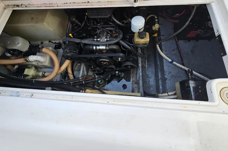 Slide: The Image of Engine compartment of 2002 Four Winns 248 Vista boat, showing various mechanical components. - 20