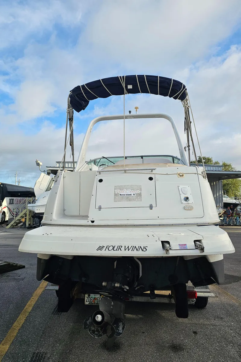 Slide: The Image of 2002 Four Winns 248 Vista boat, rear view, parked on a lot. - 22