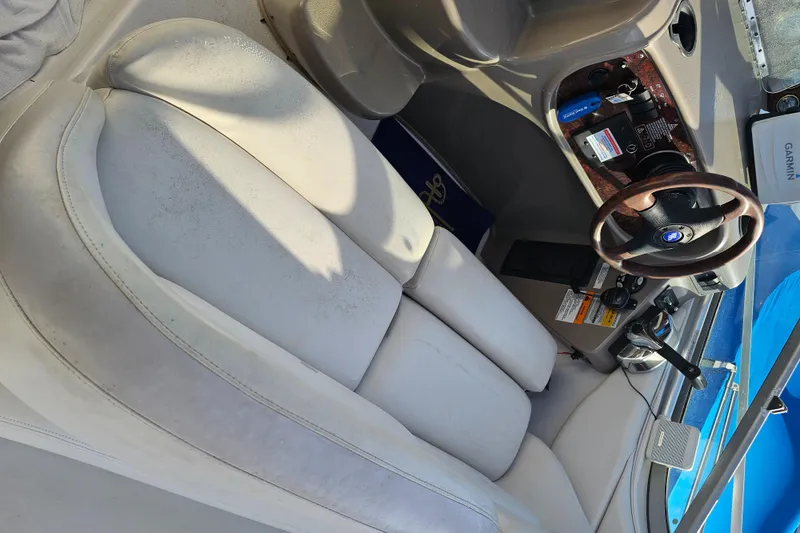 Slide: The Image of Interior of 2002 Four Winns 248 Vista boat with steering wheel and seating. - 6