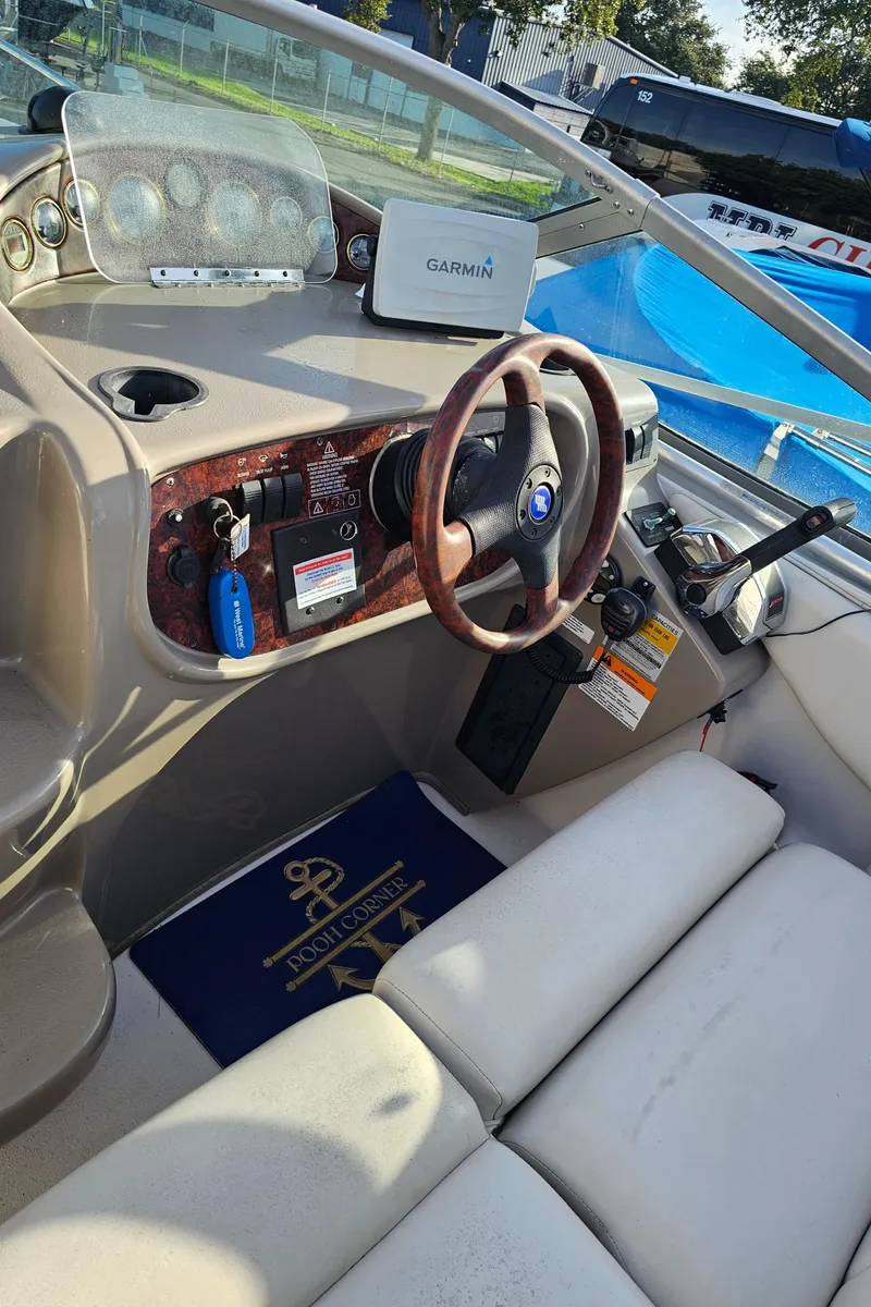 Slide: The Image of Interior of 2002 Four Winns 248 Vista boat with steering wheel and dashboard. - 7