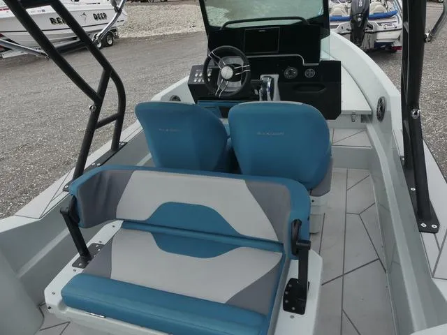 Slide: The Image of 2022 Saxdor SX 200 boat interior with blue and gray seating, steering console, and modern design. - 14