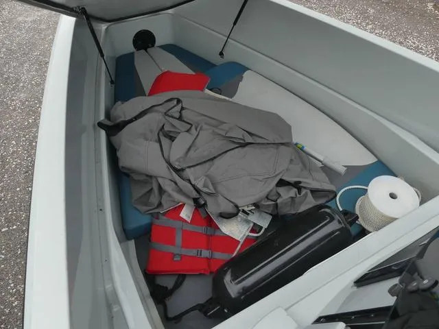 Slide: The Image of 2022 Saxdor SX 200 boat interior with life jacket, tarp, and boating equipment. - 16