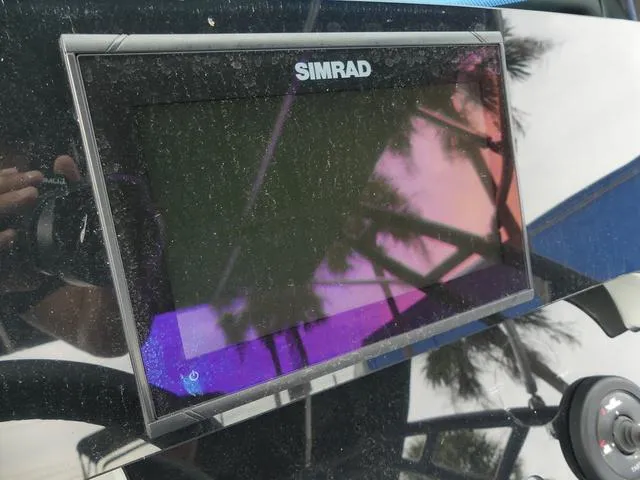 Slide: The Image of Simrad display on 2022 Saxdor SX 200 boat dashboard, reflecting palm trees. - 27