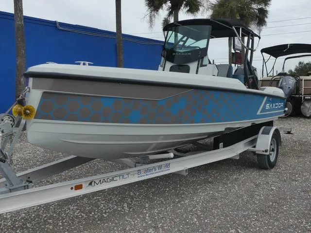 Slide: The Image of 2022 Saxdor SX 200 boat on trailer, blue and gray design, parked outdoors. - 3