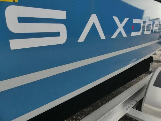 Slide: The Image of Close-up of 2022 Saxdor SX 200 boat logo on blue hull. - 43