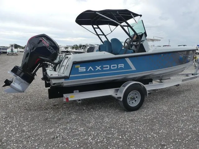 Slide: The Image of 2022 Saxdor SX 200 boat on trailer, blue exterior, outboard motor, parked on gravel. - 8