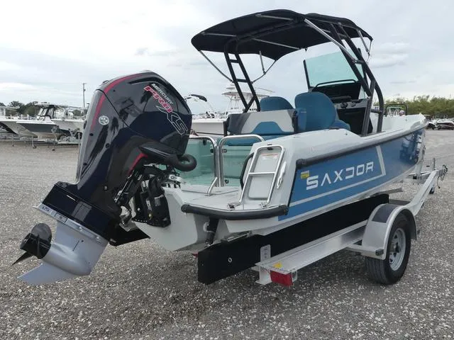 Slide: The Image of 2022 Saxdor SX 200 boat on trailer with outboard motor, parked outdoors. - 9