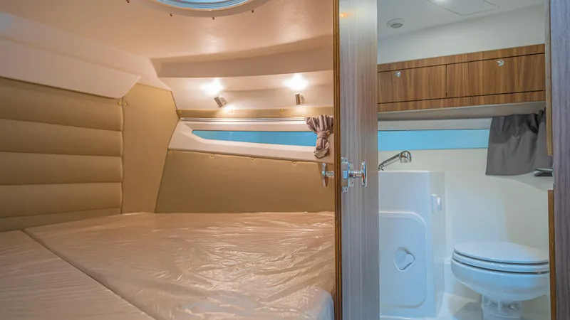 Slide: The Image of 2024 Skamander 920 Explorer MAX cabin interior with bed and compact bathroom. - 10