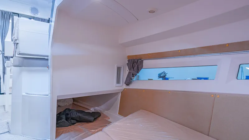 Slide: The Image of 2024 Skamander 920 Explorer MAX cabin interior with bed and window view. - 11