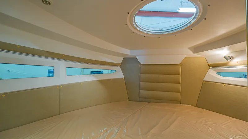 Slide: The Image of 2024 Skamander 920 Explorer MAX cabin interior with circular skylight and beige upholstery. - 12