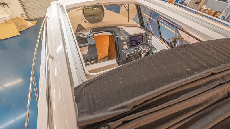 Slide: The Image of 2024 Skamander 920 Explorer MAX boat interior with modern dashboard and seating. - 15