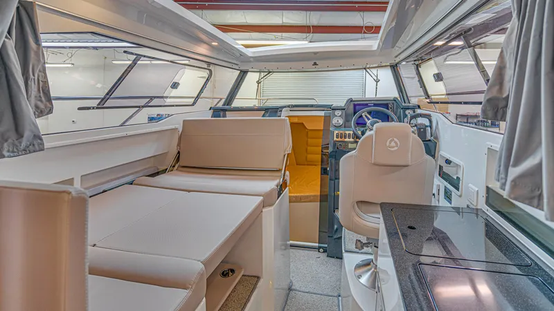 Slide: The Image of Interior of 2024 Skamander 920 Explorer MAX boat with modern seating and navigation area. - 16