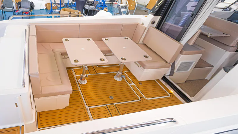 Slide: The Image of 2024 Skamander 920 Explorer MAX boat interior with seating and tables. - 18
