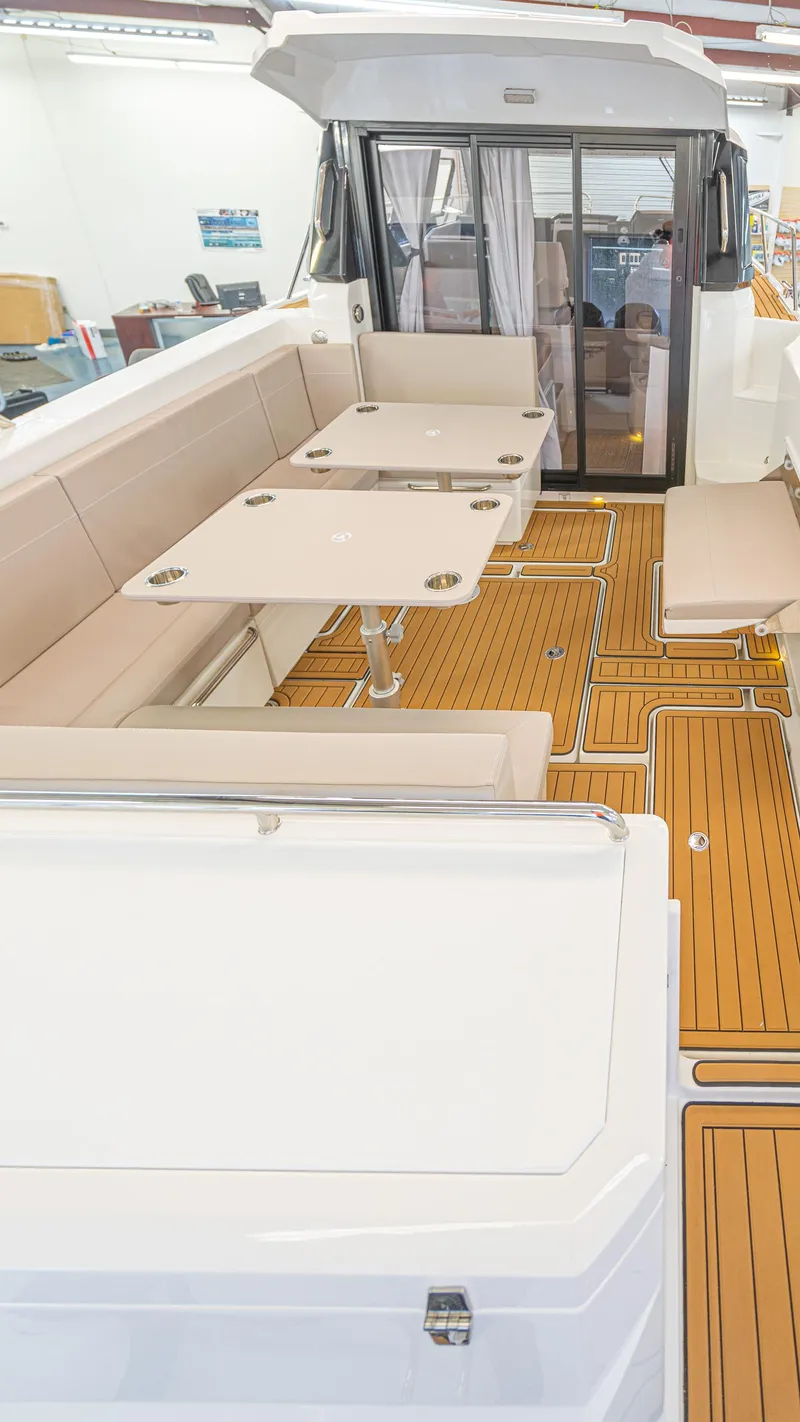 Slide: The Image of 2024 Skamander 920 Explorer MAX boat interior with seating and wooden flooring. - 20