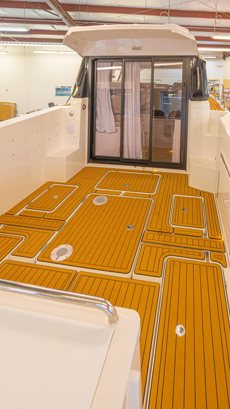Slide: The Image of 2024 Skamander 920 Explorer MAX boat deck with sleek wood finish. - 22