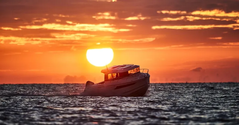 Slide: The Image of 2024 Skamander 920 Explorer MAX boat at sunset on the ocean. - 25