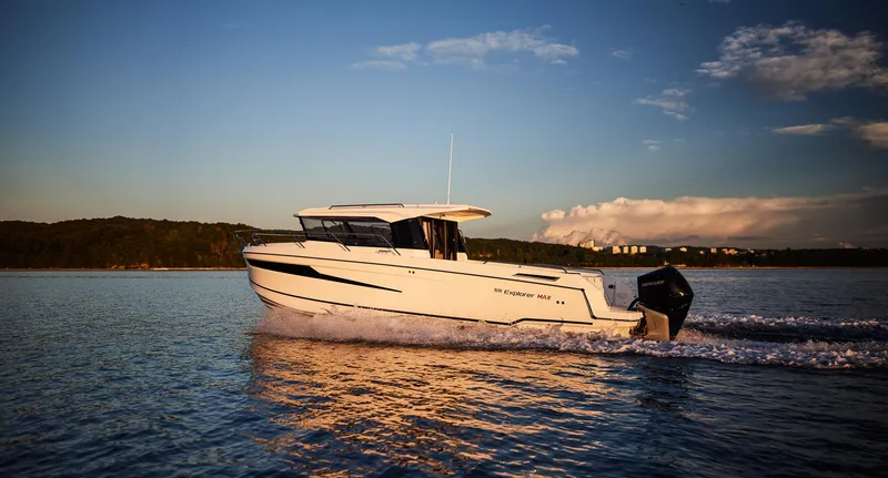 Slide: The Image of 2024 Skamander 920 Explorer MAX cruising on a serene lake at sunset. - 26