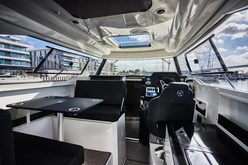 Slide: The Image of Interior of 2024 Skamander 920 Explorer MAX boat, featuring modern seating and navigation area. - 28