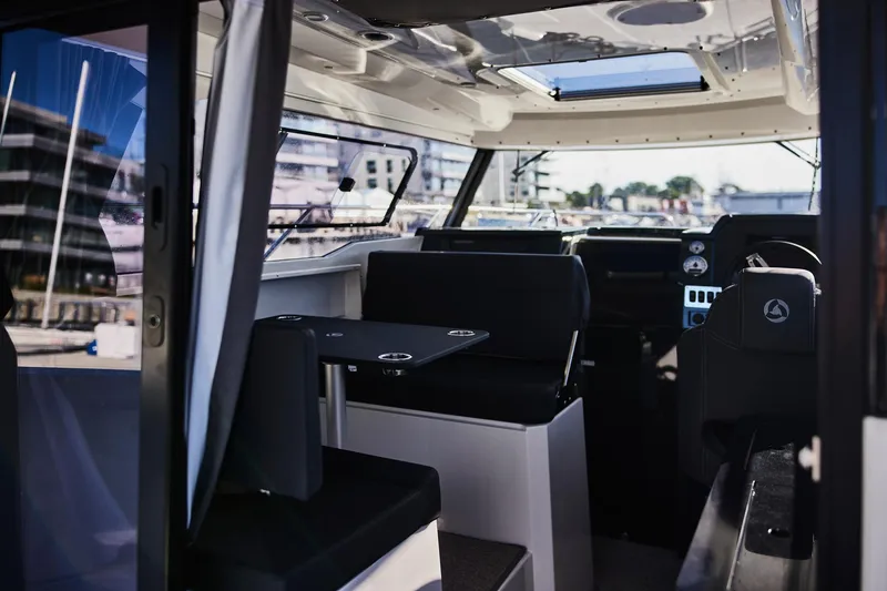 Slide: The Image of Interior of 2024 Skamander 920 Explorer MAX boat, featuring modern seating and navigation area. - 34