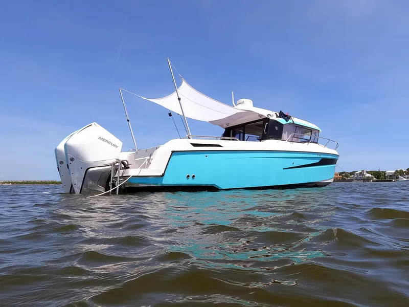 Slide: The Image of 2024 Skamander 920 Explorer MAX boat on water, featuring sleek design and modern outboard motor. - 39