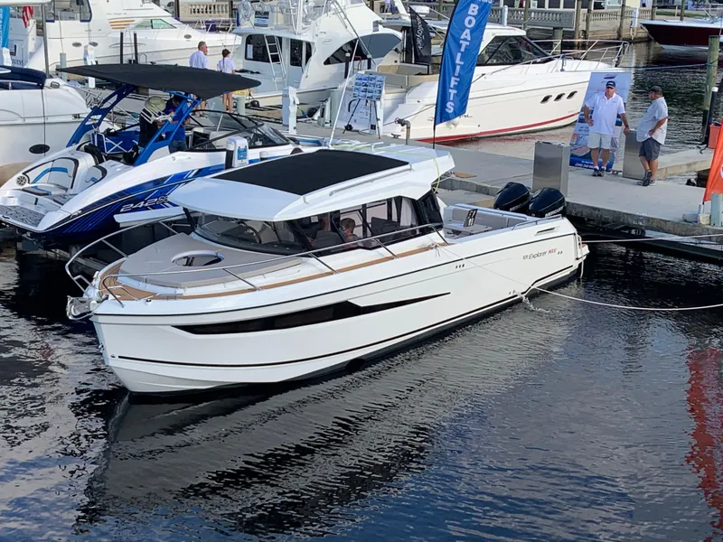 Slide: The Image of 2024 Skamander 920 Explorer MAX boat docked at marina. - 4