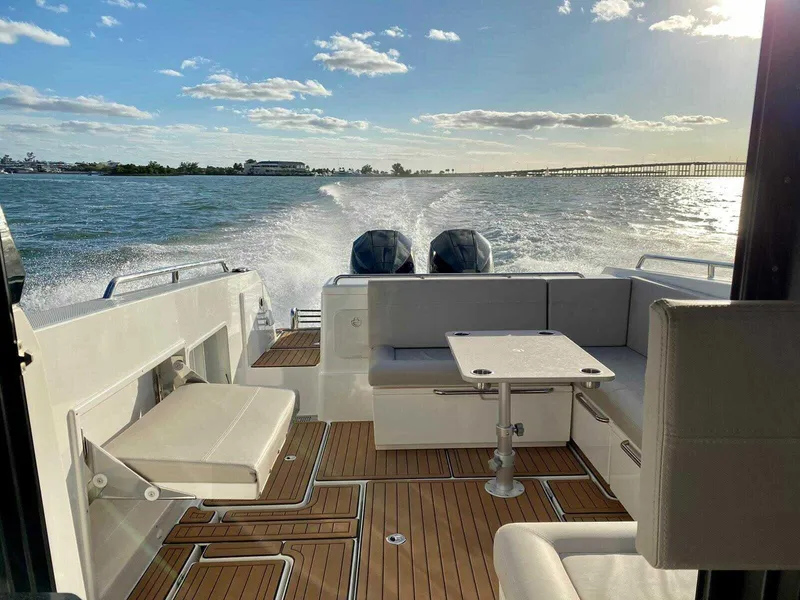 Slide: The Image of 2024 Skamander 920 Explorer MAX cruising on open water, featuring spacious deck seating. - 5