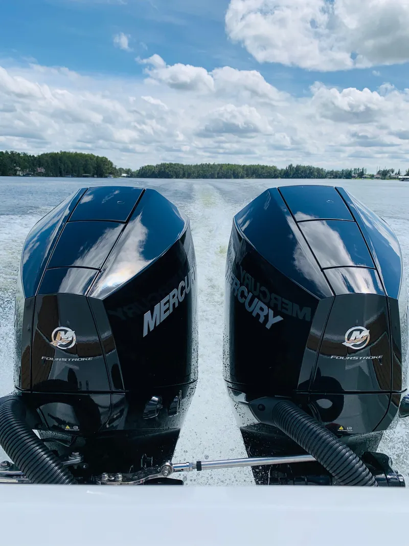 Slide: The Image of 2024 Skamander 920 Explorer MAX with dual Mercury outboard engines on a lake. - 7