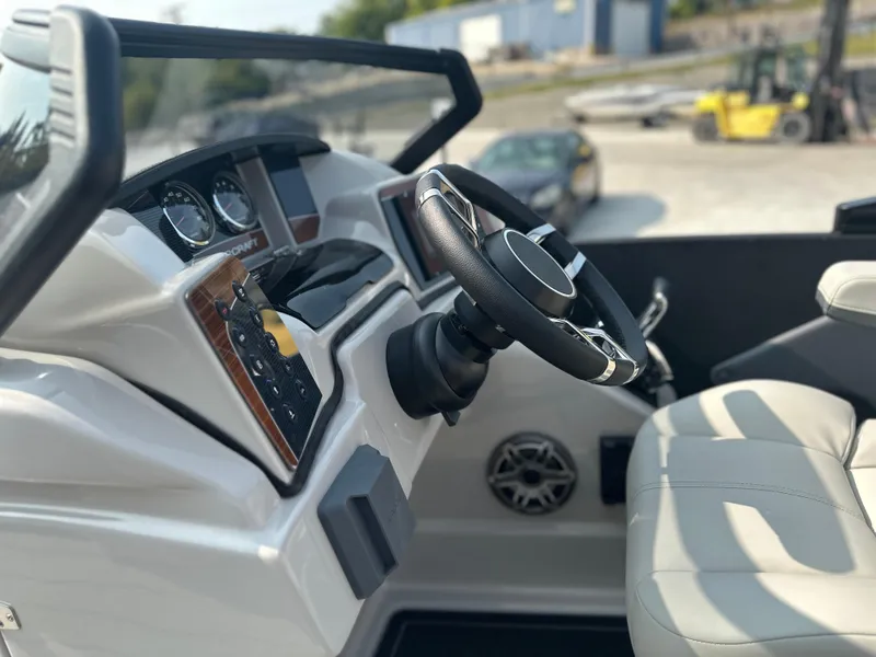 Slide: The Image of 2025 Starcraft RX 25 DL DC boat interior with steering wheel and dashboard controls. - 14