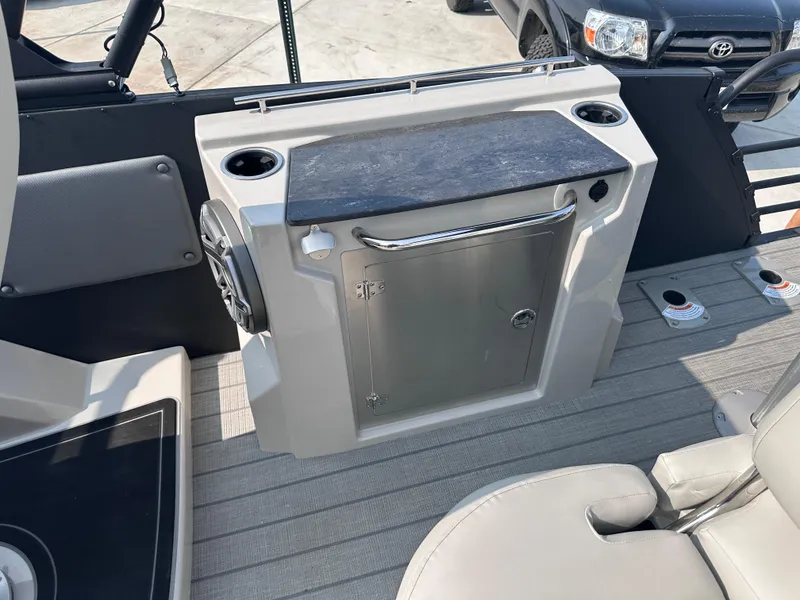 Slide: The Image of 2025 Starcraft RX 25 DL DC boat interior with seating and storage. - 18