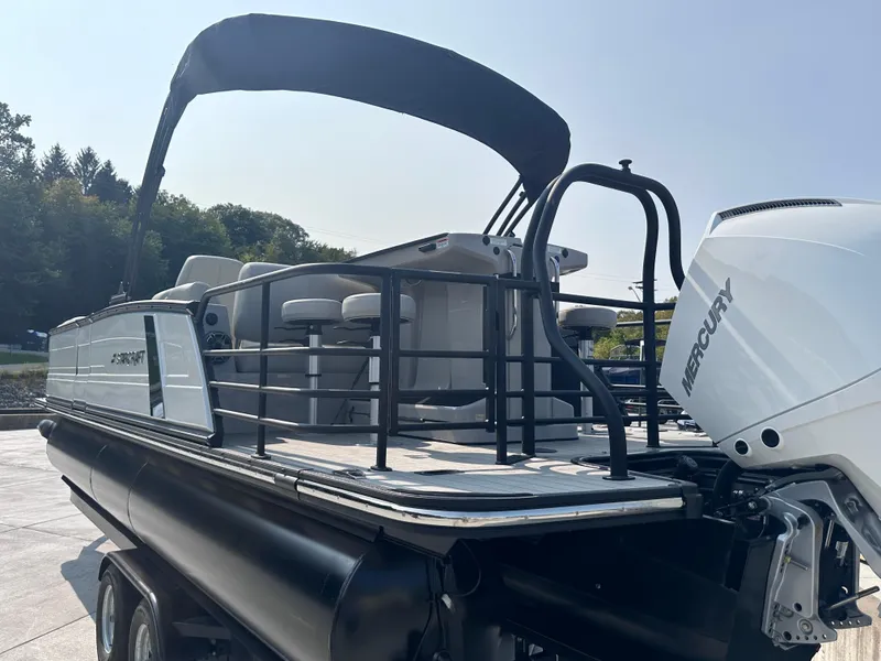 Slide: The Image of 2025 Starcraft RX 25 DL DC pontoon boat with Mercury engine, docked outdoors. - 20