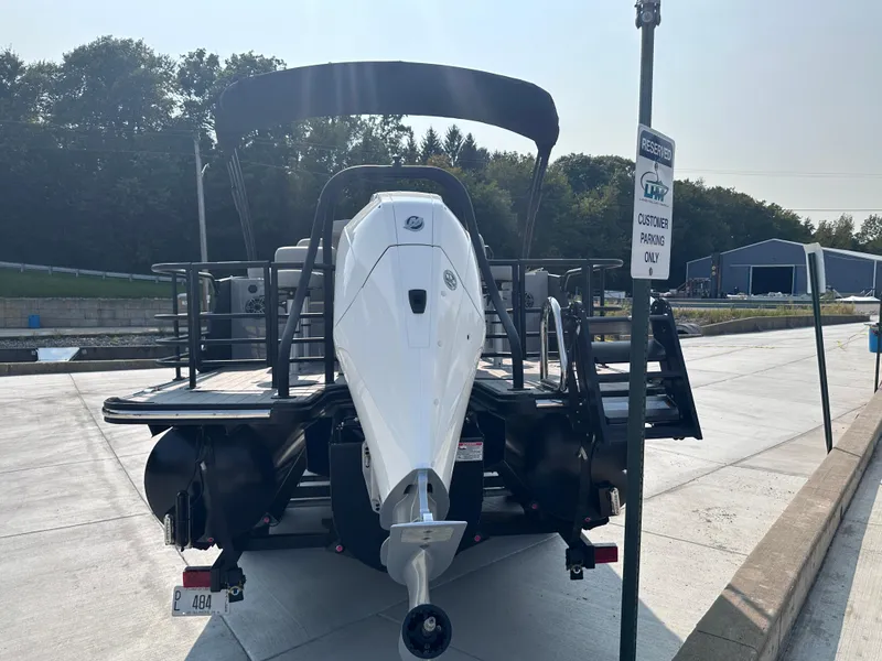 Slide: The Image of 2025 Starcraft RX 25 DL DC boat at dock, rear view, sunny day. - 21