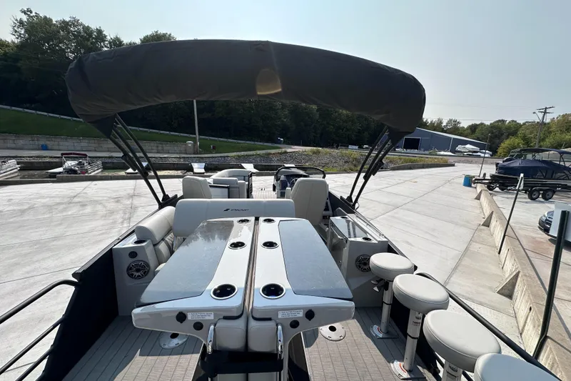Slide: The Image of 2025 Starcraft RX 25 DL DC boat interior with seating and canopy. - 23