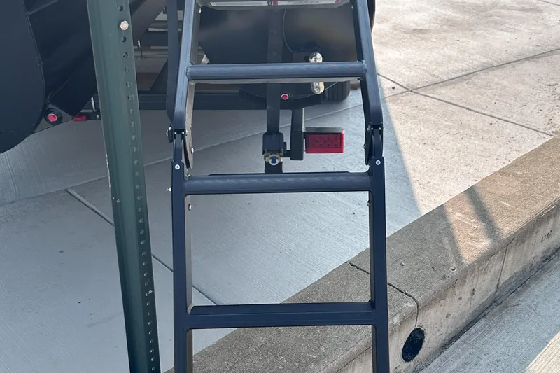 Slide: The Image of Starcraft RX 25 DL DC 2025 boat ladder on concrete surface. - 25