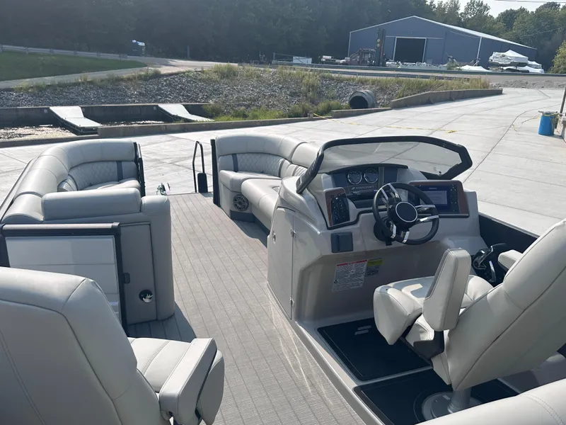 Slide: The Image of 2025 Starcraft RX 25 DL DC pontoon boat interior with modern seating and steering console. - 5