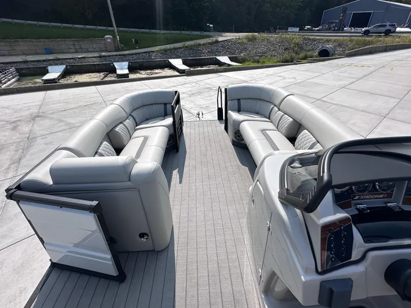 Slide: The Image of 2025 Starcraft RX 25 DL DC pontoon boat with spacious seating and modern dashboard. - 9