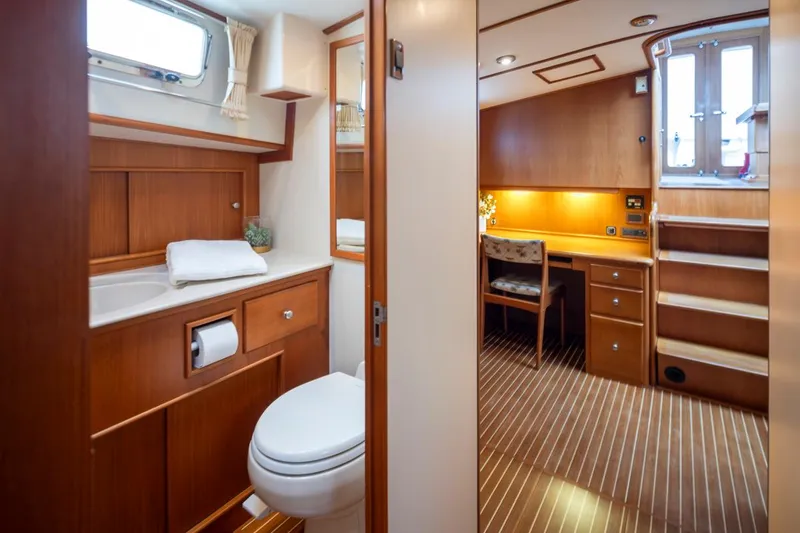 Slide: The Image of Luxurious 2003 Grand Banks Eastbay 54 SX yacht interior with bathroom and wooden cabinetry. - 20