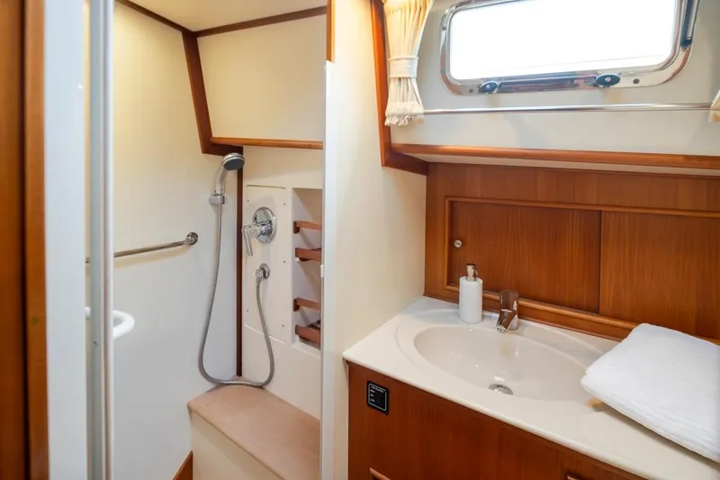 Slide: The Image of Luxurious bathroom in 2003 Grand Banks Eastbay 54 SX yacht with shower and sink. - 22