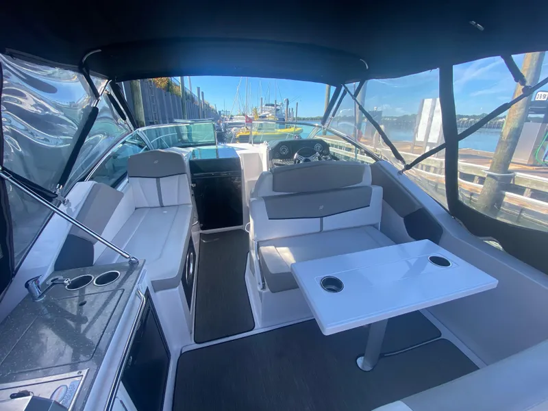 Slide: The Image of Interior of 2019 Four Winns Vista 275 boat with seating and table. - 2