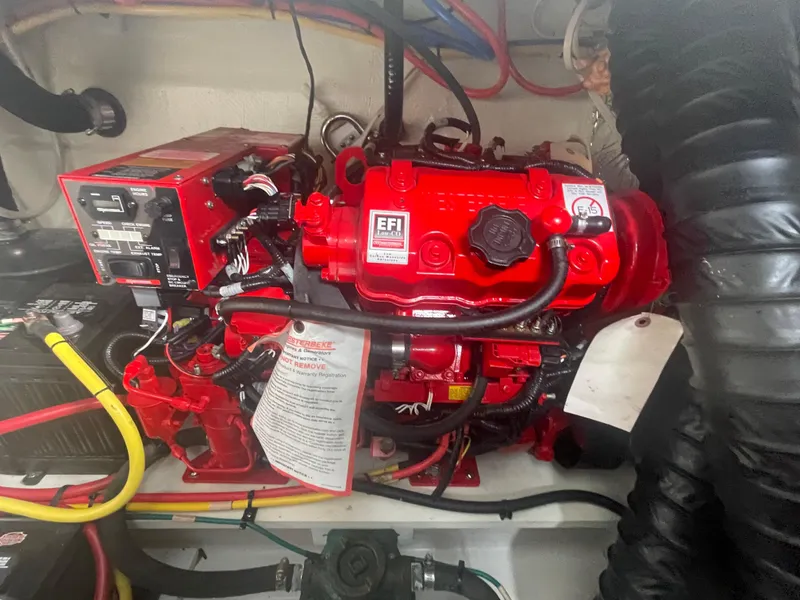 Slide: The Image of Engine compartment of 2019 Four Winns Vista 275 boat, featuring red EFI engine components. - 26