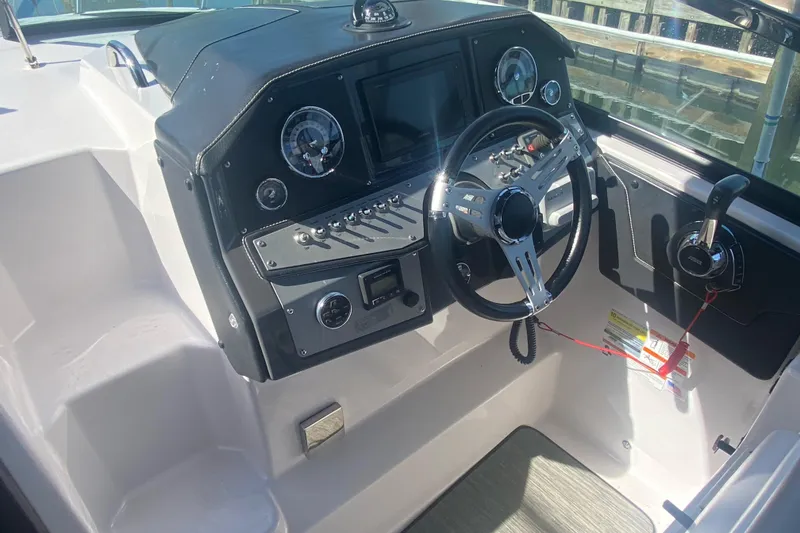 Slide: The Image of 2019 Four Winns Vista 275 boat cockpit with steering wheel and control panel. - 3