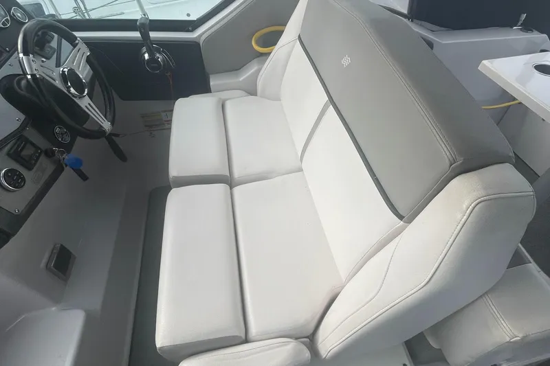 Slide: The Image of 2019 Four Winns Vista 275 boat interior with plush seating and modern dashboard. - 30
