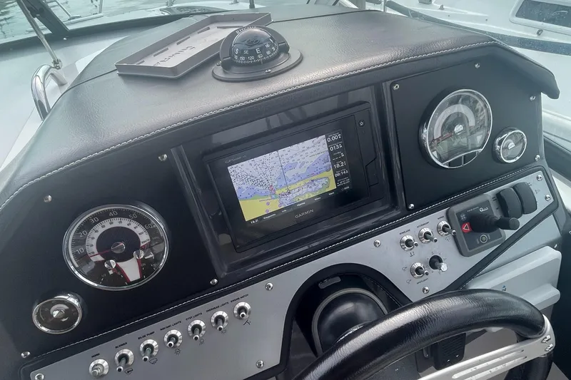 Slide: The Image of 2019 Four Winns Vista 275 dashboard with navigation system and gauges. - 37