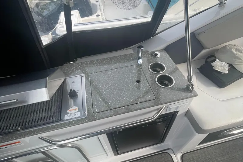 Slide: The Image of 2019 Four Winns Vista 275 boat kitchenette with sink, grill, and cup holders. - 39
