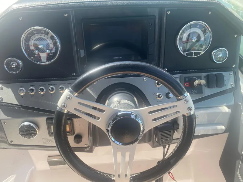 Slide: The Image of 2019 Four Winns Vista 275 dashboard with steering wheel and gauges. - 4