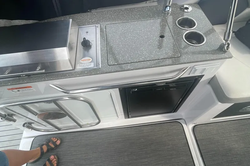 Slide: The Image of 2019 Four Winns Vista 275 boat kitchenette with sink, grill, and storage. - 40