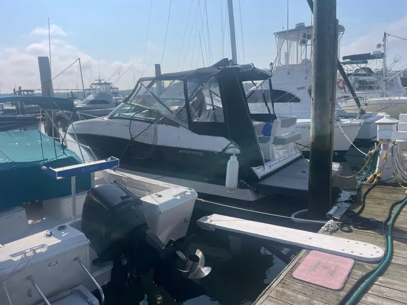 Slide: The Image of 2019 Four Winns Vista 275 boat docked at marina. - 44