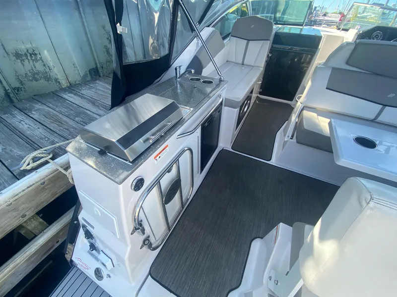 Slide: The Image of 2019 Four Winns Vista 275 boat interior with seating and kitchenette area. - 5