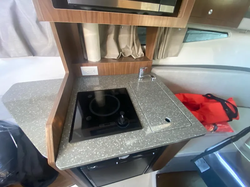 Slide: The Image of 2019 Four Winns Vista 275 boat kitchen with stove and sink. - 6