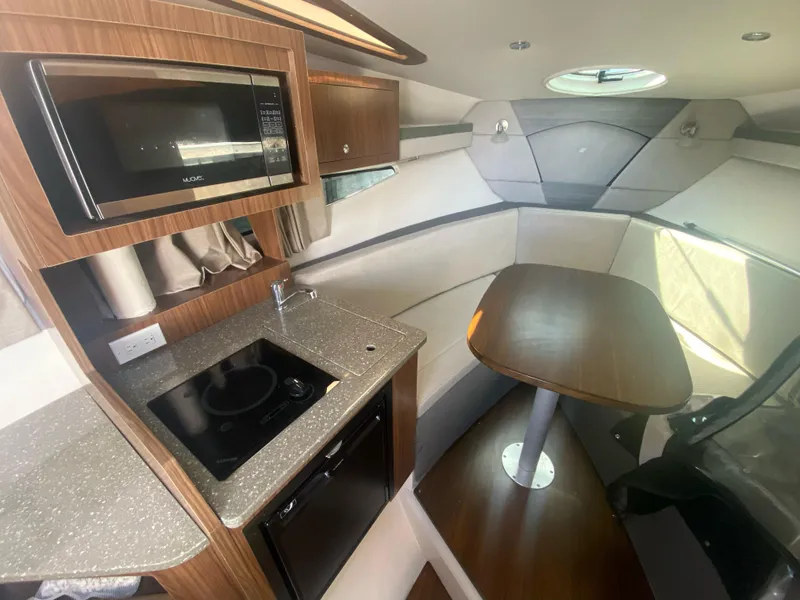 Slide: The Image of 2019 Four Winns Vista 275 interior with kitchenette and dining area. - 7